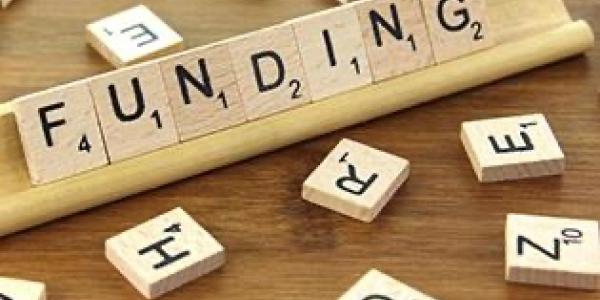 Word Funding spelled out in scrabble pieces